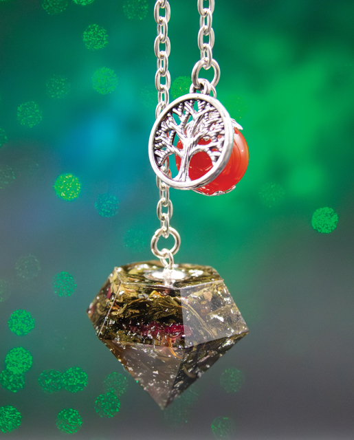 Radiant Soul pendulum with carnelian bead and silver tree of life charm, handmade with green tea leaves, rose petals, and silver leaf.