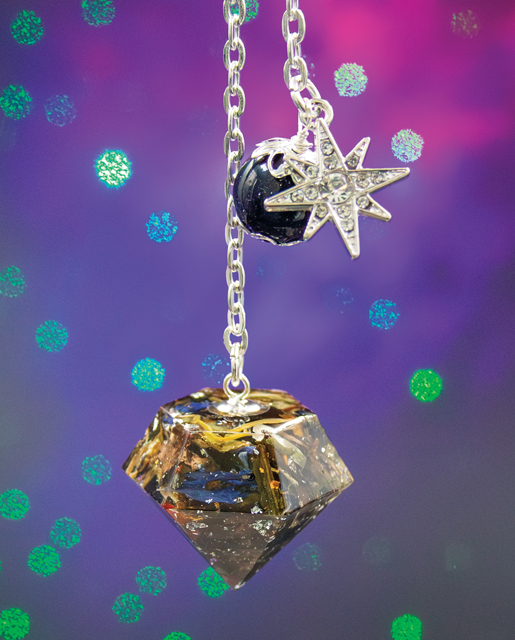 Starry Night pendulum with blue goldstone bead and silver eight-pointed star charm, handmade with white tea leaves, rose petals, cornflowers, saffron, and silver leaf.